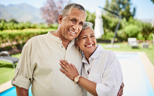 Retirement, yard and senior couple on holiday in summer hug together with love for marriage, wealth or luxury lifestyle. Elderly people in backyard, patio or vacation home in an outdoor portrait