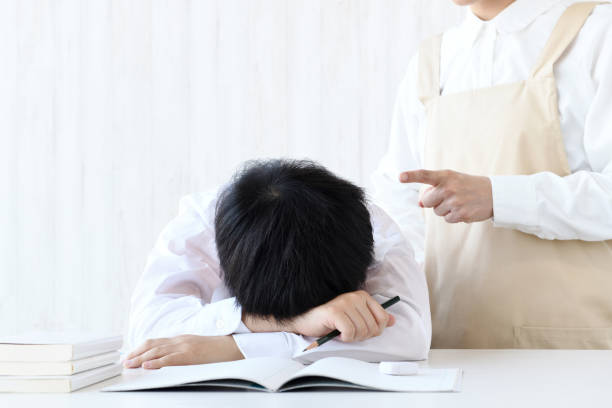 istock Boy lying face down on desk and scolding mother 1437852395