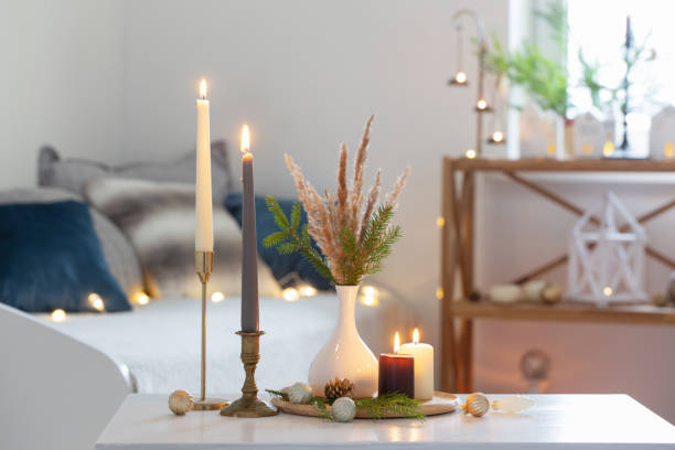 istock burning candles with christmas decor in white cozy interior 1437853108