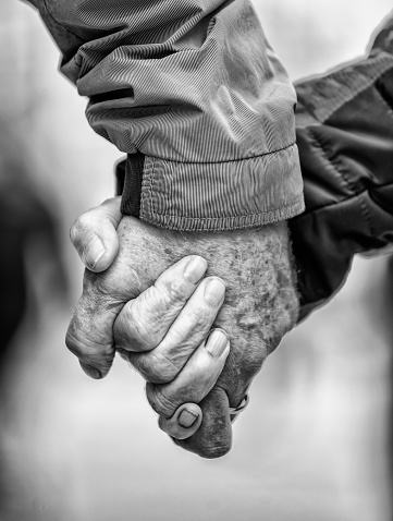 Elderly couple holding hands together. Seniors love