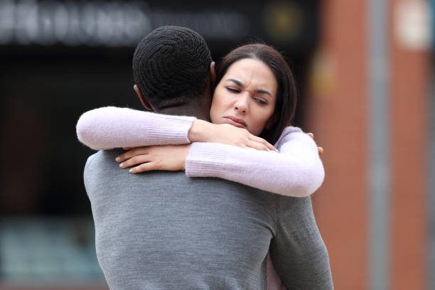 istock Disappointed woman hugging a black man 1437853810