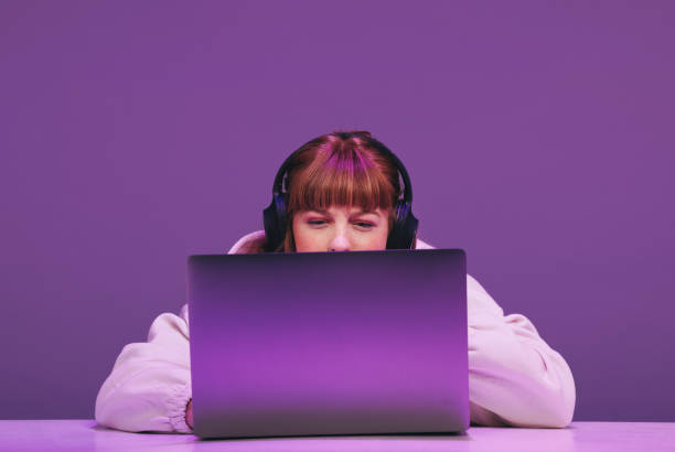 istock Woman playing an online video game on her laptop 1437853852