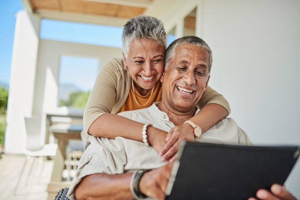 tablet, retirement and senior couple on outdoor patio reading website for online quote, wealth and asset management research. elderly, senior people happy with digital app life insurance information - senior adult happiness computer looking at camera imagens e fotografias de stock