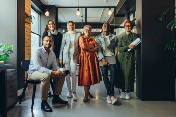 istock Multicultural business team smiling at the camera in an office 1437854189