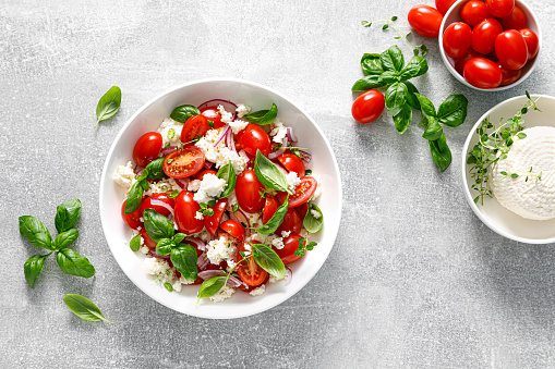 Salad with tomato, italian ricotta cheese and basil, top view