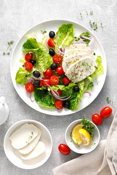 istock Salad with mozzarella cheese, cherry tomato, olives and romain lettuce, top view 1437855157