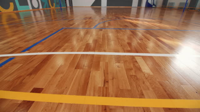 Parquet floor with color markings in gym for basketball