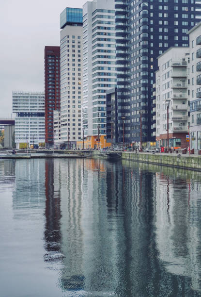 istock View of buildings by river against cloudy sky 1437855752