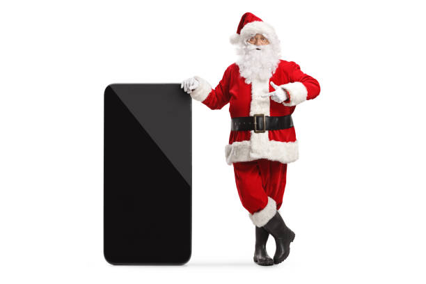 istock Santa claus leaning on a big mobile phone and pointing 1437857197