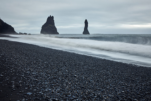 Long exposure shot of Reynisdrangar rock formations at black sand beach in South Iceland