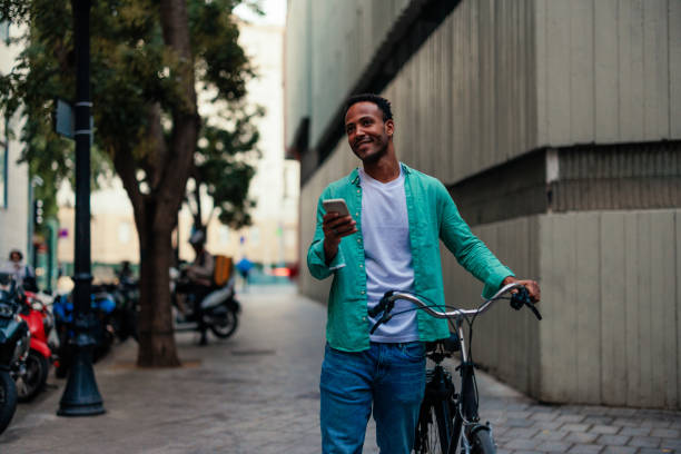 istock Man with bicycle and mobile phone outside. 1437858301