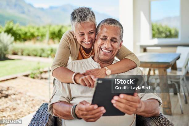 Outdoor Online And Senior Couple Using A Tablet For Video Call Internet And Social Media Old Man And Woman With Digital Tech For Chatting Call And Texting On Retirement Home Patio In Mexico Stock Photo - Download Image Now