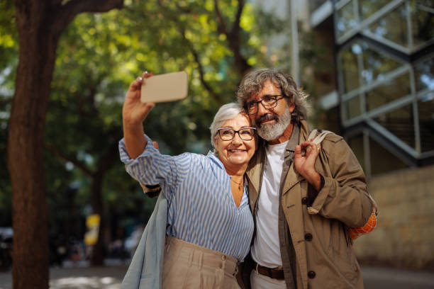 istock Cheerful seniors take selfie outside. 1437859699