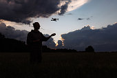 Man controlling a drone with a remote control