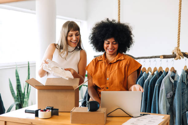 istock Online store owners preparing clothing parcels for shipping 1437862780