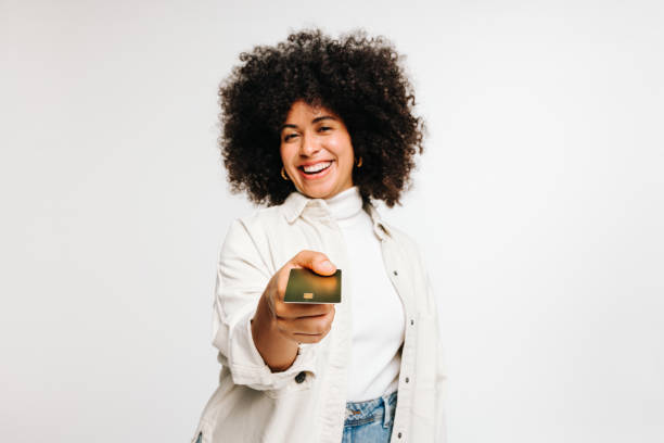 istock Cheerful young woman paying with a credit card 1437862906