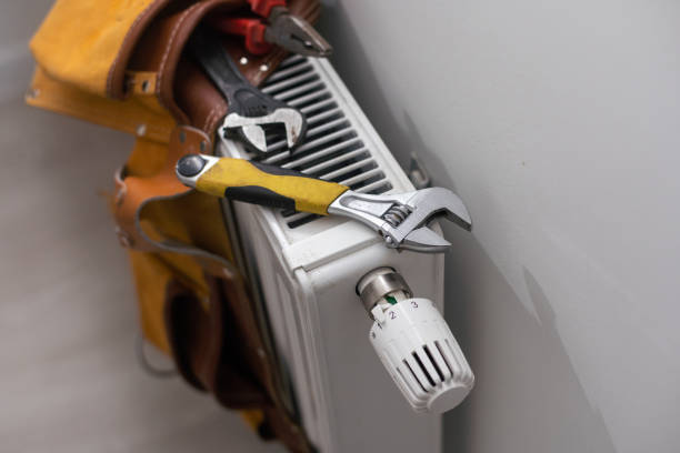 istock tools on the radiator. water heating radiator on the white wall indoors. 1437864010