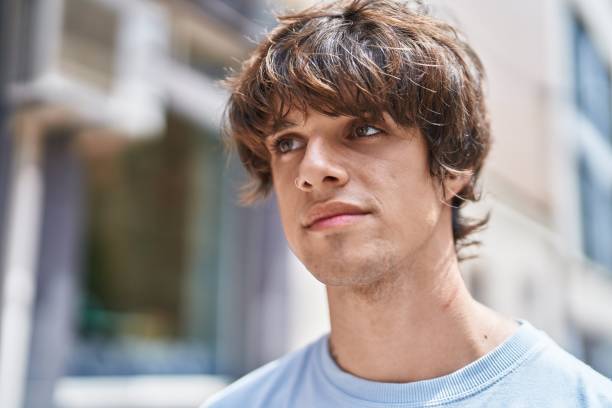 istock Young blond man looking to the side with serious expression at street 1437865436