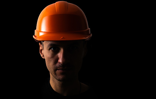 Miner, wearing helmet, in black.