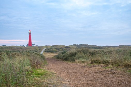 The red-white ringed lighthouse Amrum is built on top of a sand dune and is part of the community Nebel (Germany, Isle of Amrum, Schleswig-Holstein, North Frisia).