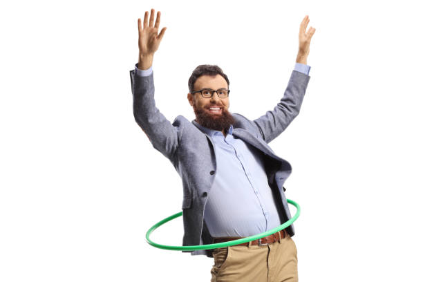 istock Happy bearded man spinning a hula hoop and smiling 1437870343