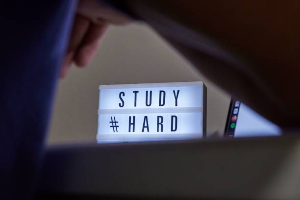 istock Lamp and a desk with text study hard time on a table in the room 1437871581