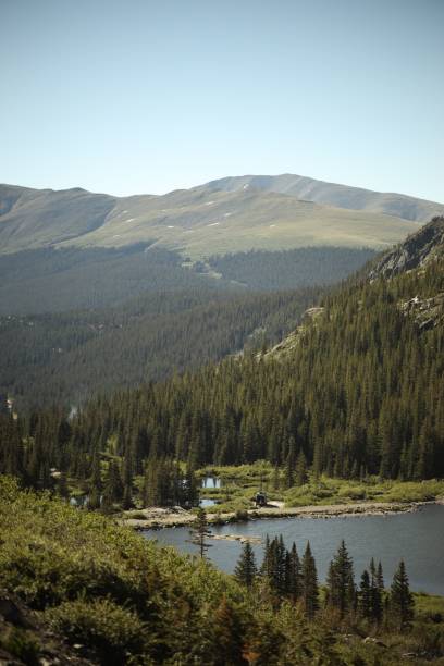 istock Vertical shot of a forest and hills surrounded by a lake 1437871817