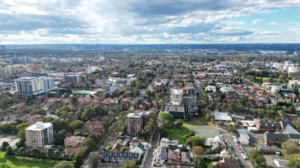 istock Aerial view of buildings and trees with a cloudy sky background 1437872021