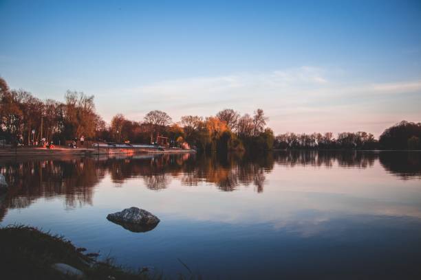 istock Autumn trees with reflection in a lake under cloudy sky 1437872318