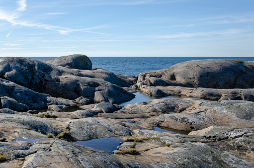 View of the archipelago in Gothenburg. Blue sky and sea, cliffs. A nice day in Sweden. Blue sky background, place for text, copy space.