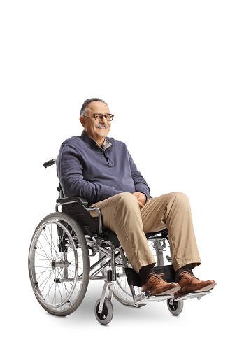 Mature man sitting in a wheelchair isolated on white background