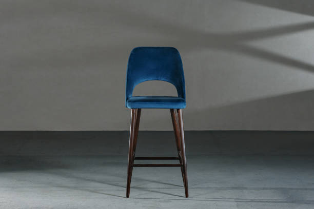 istock Blue dining room chair in a studio with gray walls 1437874833