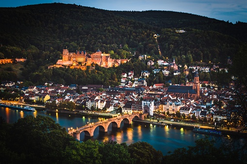 An aerial view of cityscape Heidelberg surrounded by water in evening