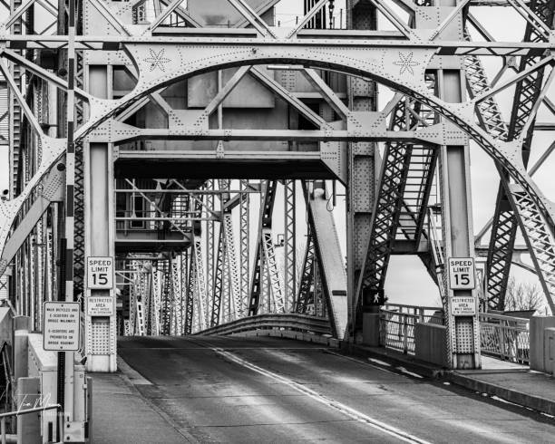 istock Road surrounded by steel bridge in black and white 1437875125