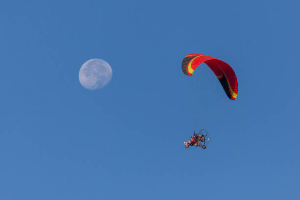 istock People powered paragliding  in the sky 1437875429