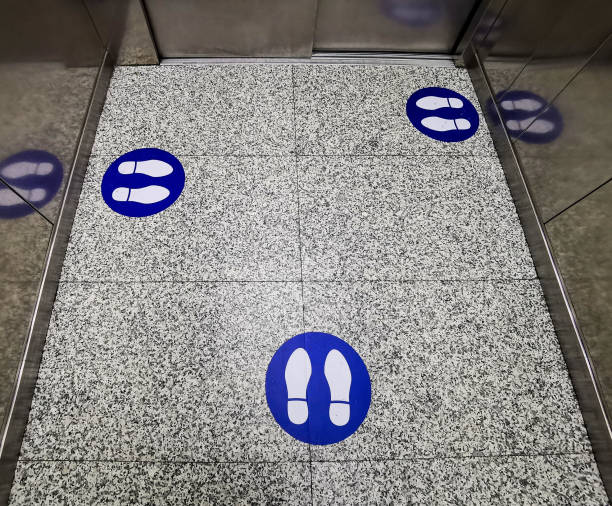 istock High angle shot of footprints on the elevator - Social Distancing 1437875439