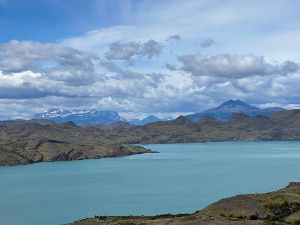 istock Wide river against rocky mountains view under the blue cloudy sky 1437875454