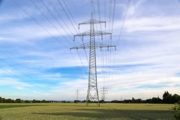 istock Giant transmission tower in the field under the cloudy sky 1437875696