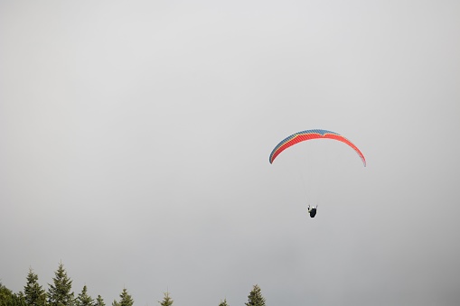 Paraglider flying over Carpathian mountains