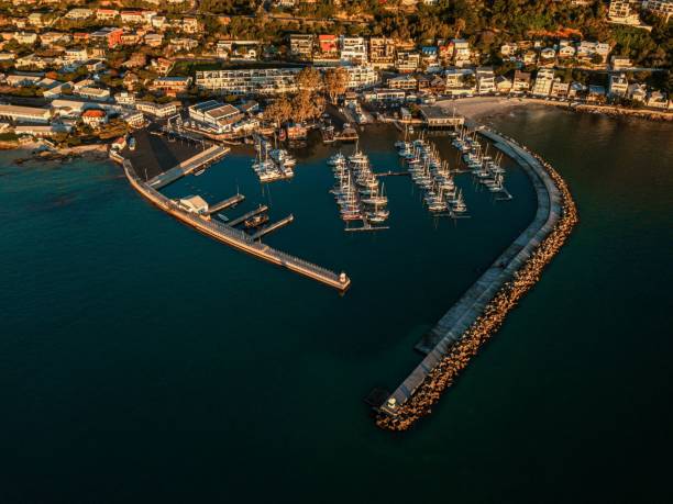 Aerial view of sailing boats with buildings in the background at Gordon's Bay, South Africa An aerial view of sailing boats with buildings in the background at Gordon's Bay, South Africa gordons bay stock pictures, royalty-free photos & images