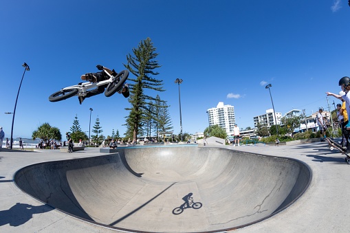Alexandra Headland, Australia – July 24, 2022: The young bike rider performing tricks in Alexandra Headland skatepark. Maroochydore, Australia.