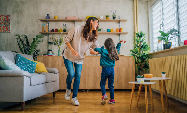 istock Mother and little daughter dancing together 1437879436