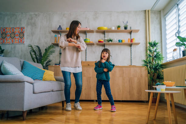 istock Mother and little daughter dancing together 1437879685