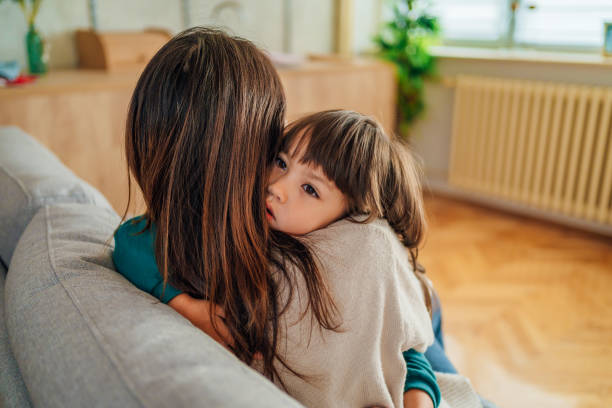 istock Mother and daughter hugging at home 1437880080