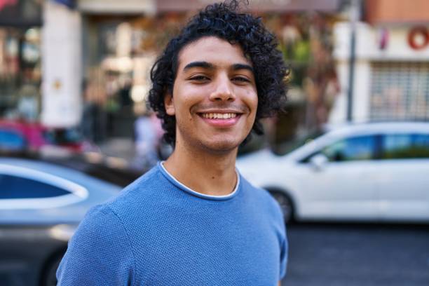 istock Young hispanic man smiling confident standing at street 1437880101