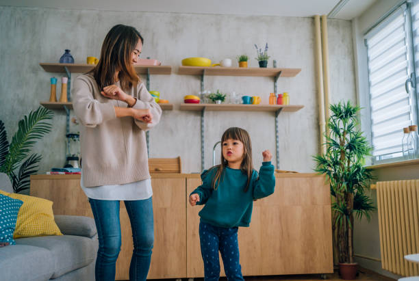 istock Mother and little daughter dancing together 1437880164