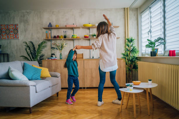 istock Mother and little daughter dancing together 1437880284