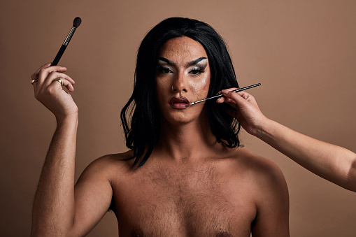Makeup, lgbtq male beauty portrait, pride and queer lifestyle with mock up studio background. Gay, unique and creative cosmetics artist person model with product advertising mock up