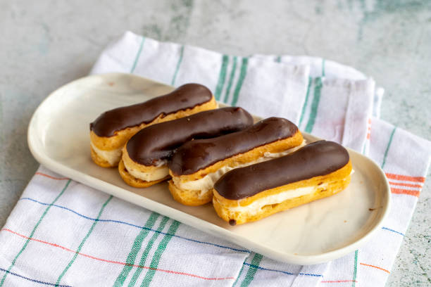 istock Chocolate eclair cake on gray background. Bakery products. close up 1437881933