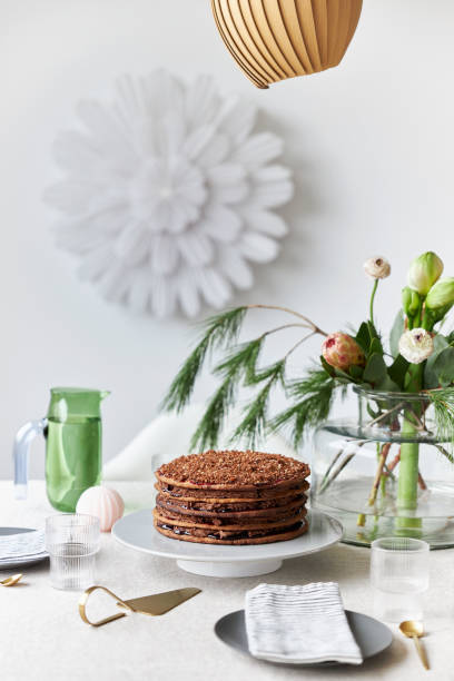 istock A gingerbread cake stands on a table decorated in a modern, Christmassy way 1437883475